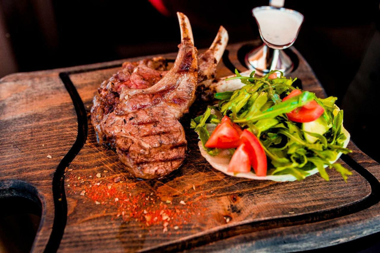 Caspian Riviera Grand Palace Hotel Aktau (Mangystau) Exterior foto A grilled lamb chop with a fresh salad